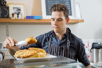 Image showing Cafe Owner Serving Sweet Food