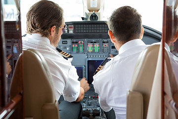 Image showing Pilot And Copilot In Private Jet Cockpit