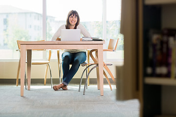 Image showing Student With Laptop Looking Away In Library