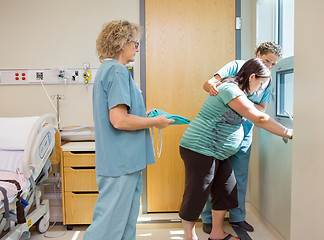 Image showing Nurse Carrying Hospital Gown For Pregnant Woman