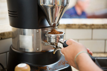 Image showing Barista Grinding Coffee