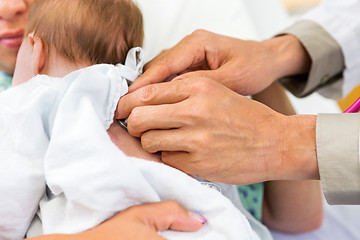 Image showing Doctor's Hands Examining Newborn Babygirl With Stethoscope