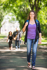 Image showing Confident Female Student Walking On Campus Road