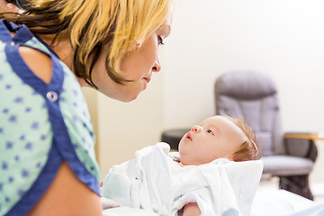 Image showing Woman Looking At Cute Newborn Babygirl In Hospital