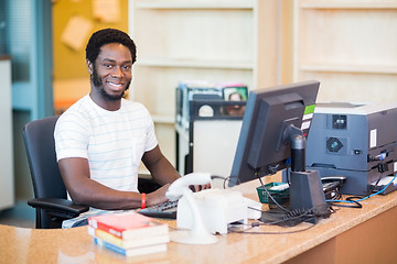 Image showing Male Librarian Working At Desk