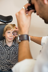 Image showing Boy Looking At Optician Examining His Eyes Through Lens