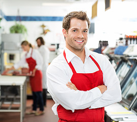 Image showing Confident Male Butcher Standing Arms Crossed At Store