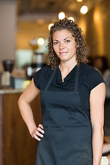 Image showing Waitress Standing With Hand On Hip In Cafe