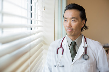 Image showing Thoughtful Doctor Looking Out Through Window