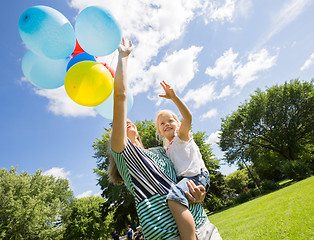 Image showing Mother And Daughter With Balloons In Park