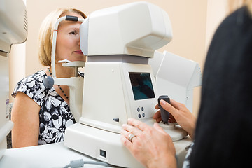 Image showing Optician Examining Patient's Eye With Tonometer