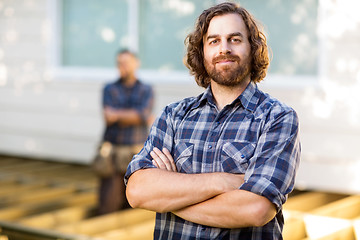 Image showing Confident Carpenter With Arms Crossed At Construction Site