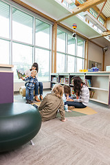 Image showing Teachers And Primary Students In Library