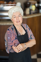 Image showing Confident Senior Owner Standing In Coffeeshop