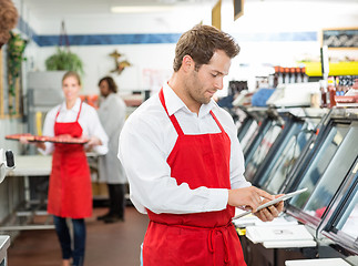 Image showing Confident Male Butcher Standing Arms Crossed At Store