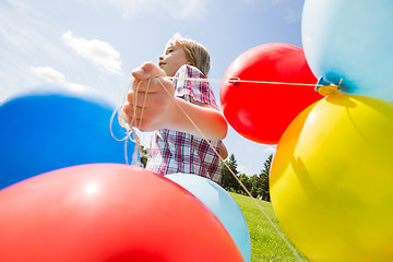 Image showing Boy With Colorful Balloons Running In Park