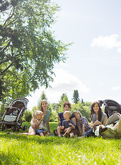 Image showing Female Friends With Their Children Enjoying Picnic