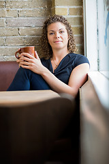 Image showing Woman Holding Coffee Cup In Cafeteria