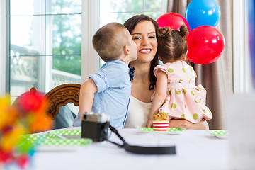 Image showing Birthday Boy Kissing Mother At Home