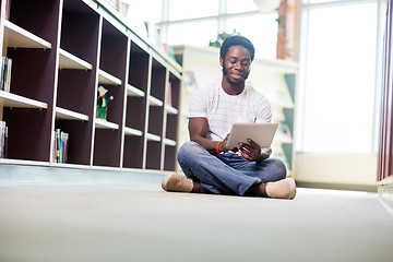 Image showing Male Student Using Digital Tablet In Library