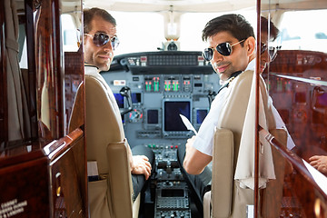 Image showing Confident Pilots In Cockpit Of Plane