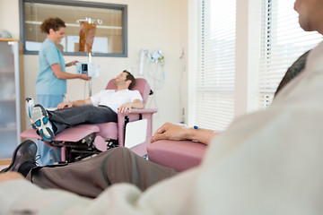 Image showing Female Nurse Adjusting IV Machine For Patient