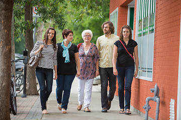 Image showing Friends Walking Together On Pavement