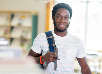 Image showing Student Standing By Bookshelf In Library