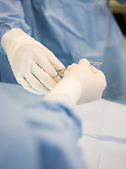 Image showing Surgeons Passing Scissors During Surgery