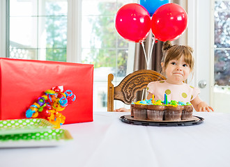 Image showing Birthday Girl With Cake And Present On Table