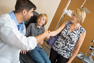 Image showing Optician And Woman Shaking Hands By Boy