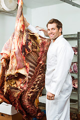 Image showing Butcher Standing in Cooler with Beef