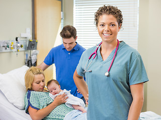 Image showing Nurse Standing With Couple And Newborn Baby In Background