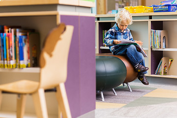 Image showing Schoolboy Reading Book In Library