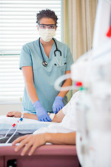 Image showing Nurse Starting Renal Dialysis on Patient