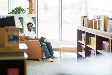 Image showing Smiling Student Reading Book In Library