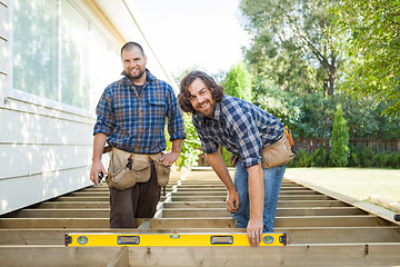 Image showing Happy Construction Workers With Spirit Level At Site