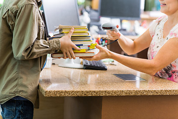 Image showing Schoolboy Holding Books At Library Counter