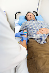 Image showing Doctor Drawing Blood From Patient's Arm