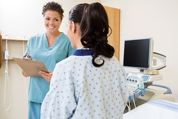 Image showing Nurse Writing Notes With Patient In Ultrasound Room