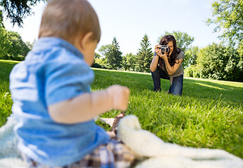 Image showing Woman Photographing Baby Boy In Park