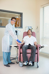 Image showing Nurse Examining Patient Receiving Intravenous Treatment In Chemo