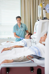 Image showing Nurse Standing By Patient Undergoing Renal Dialysis