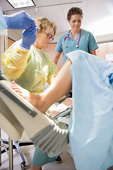 Image showing Surgeon Receiving Scissors From Colleague While Delivering Baby