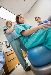 Image showing Nurse Assisting Pregnant Woman Sitting On Exercise Ball