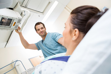 Image showing Male Nurse Adjusting Xray Machine For Patient