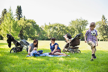 Image showing Mothers With Children Enjoying Picnic