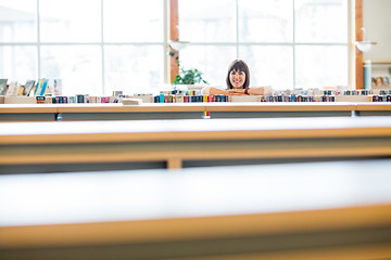 Image showing Student Leaning In Books In Library