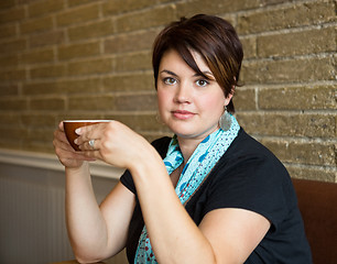 Image showing Beautiful Woman Holding Coffee Cup In cafe