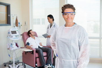 Image showing Nurse With Doctor Examining Patient's Heartbeat